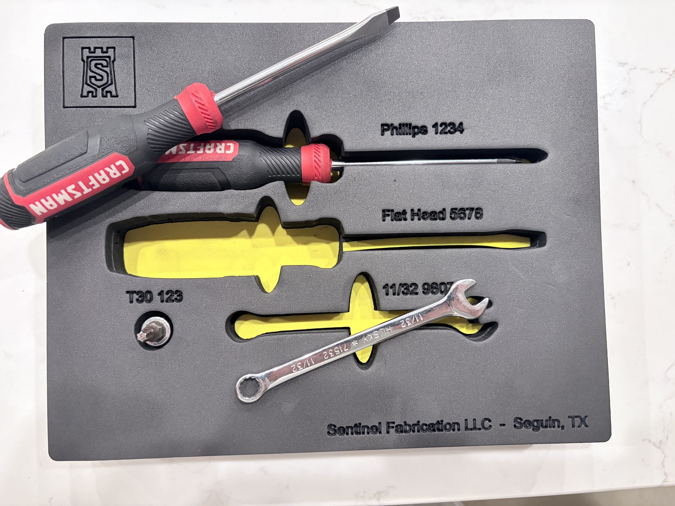 Shadow foam insert with tools lifted out, showing the yellow shadow layer underneath.