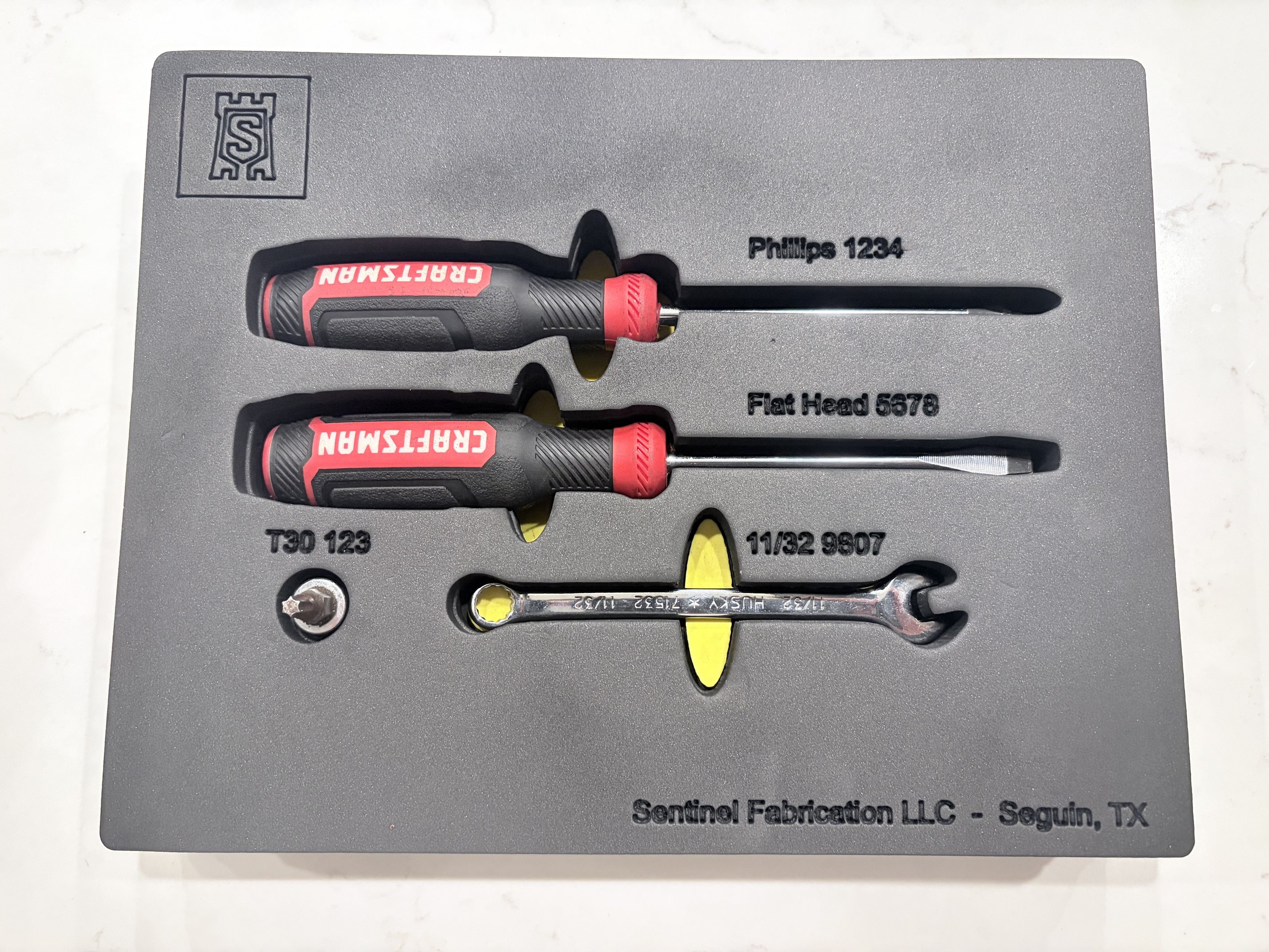 Two-tone shadow foam insert with screwdrivers, a bit socket, and a wrench cut to shape for a mobile toolbox.