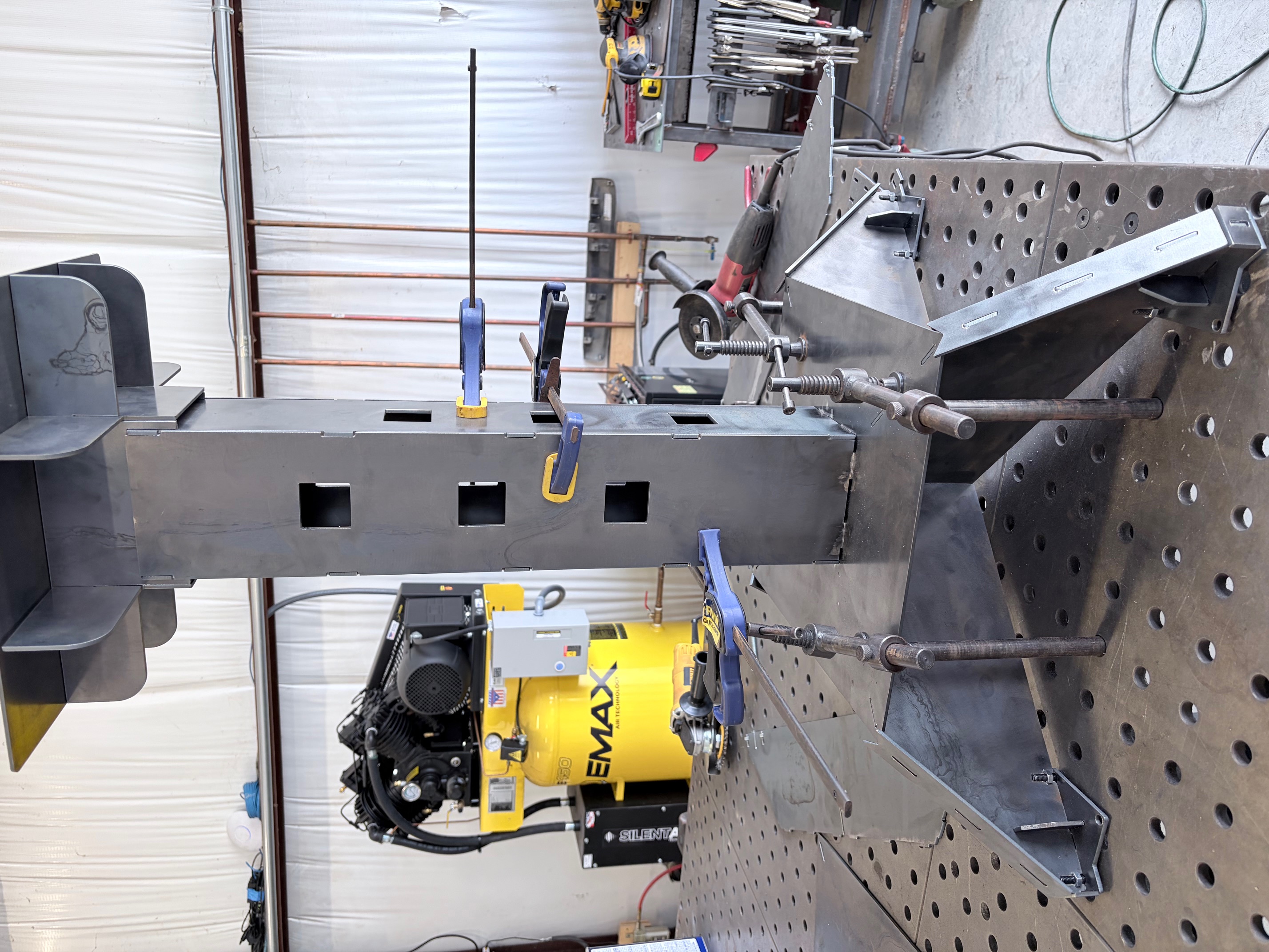 Custom fabricated steel pedestal staged and squared at fit-up before welding.