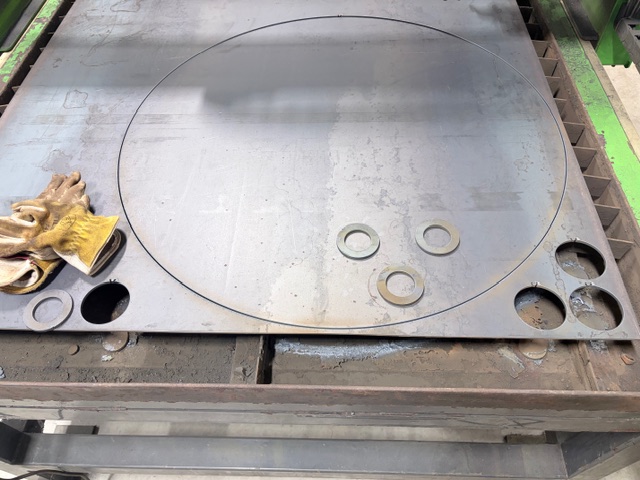 Multiple CNC plasma cut steel circles showing consistent edge quality and repeatable results.