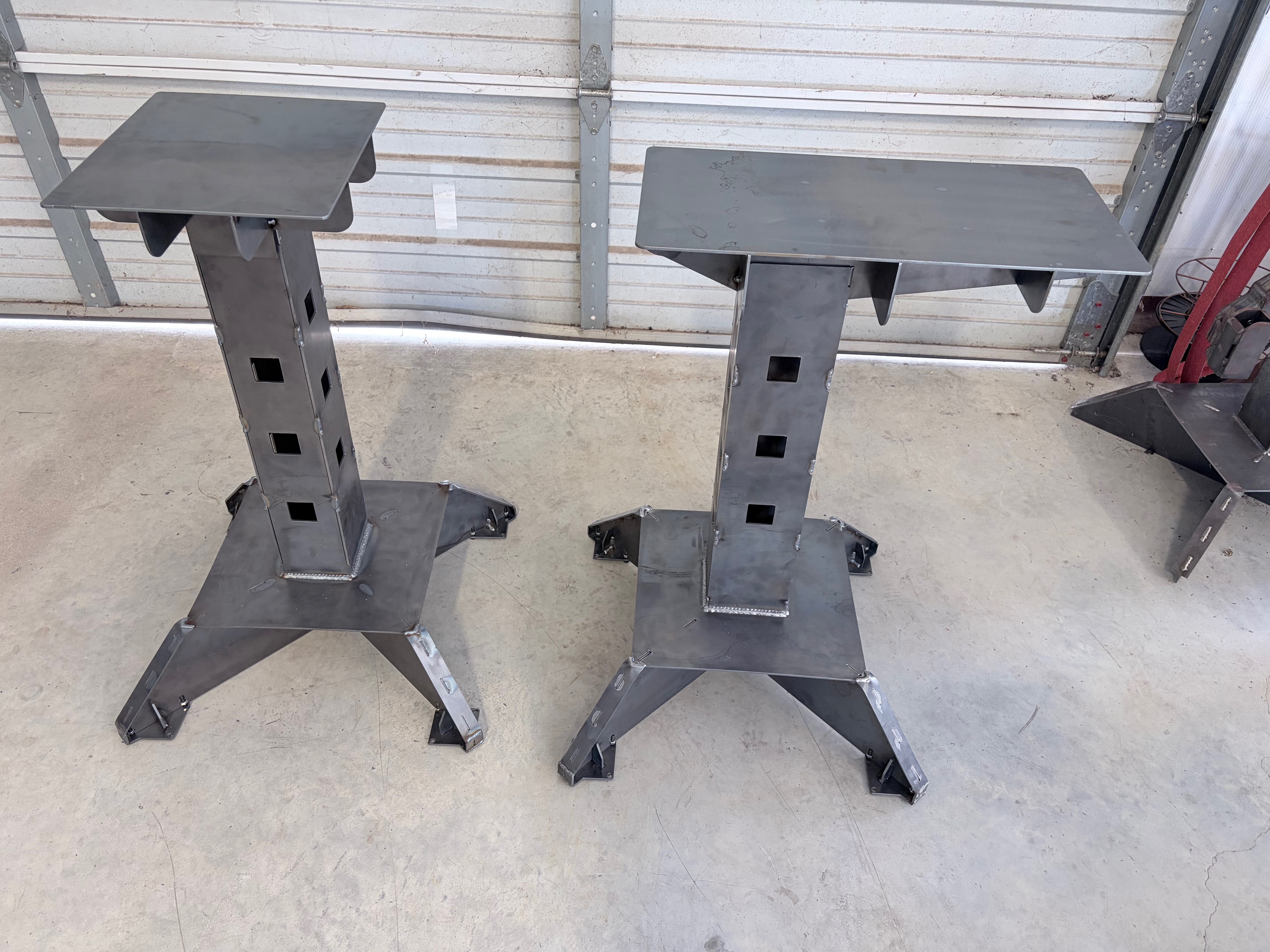 Two custom fabricated steel pedestals built in-house at Sentinel Fabrication.